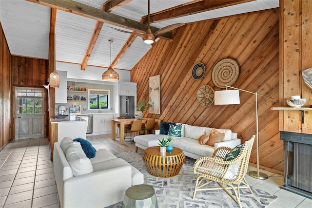 4365 S Atlantic Ave Unit B8, New Smyrna Beach, FL 32169 - living room with wood walls, light tile patterned floors, high vaulted ceiling, beam ceiling, and a fireplace
