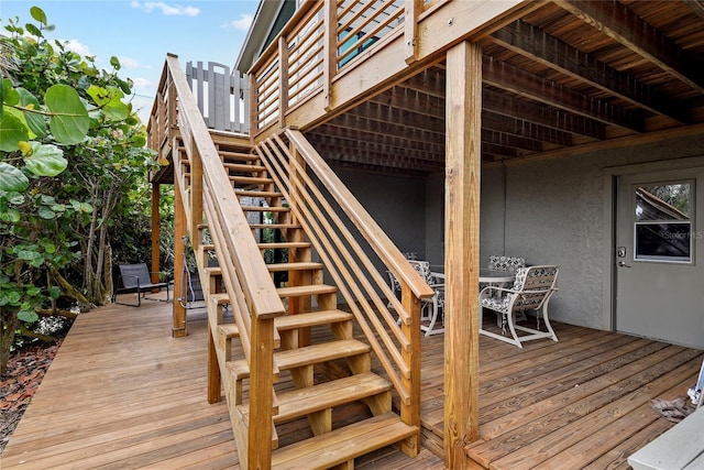 4365 S Atlantic Ave Unit B8, New Smyrna Beach, FL 32169 - wooden terrace featuring stairway and outdoor dining space