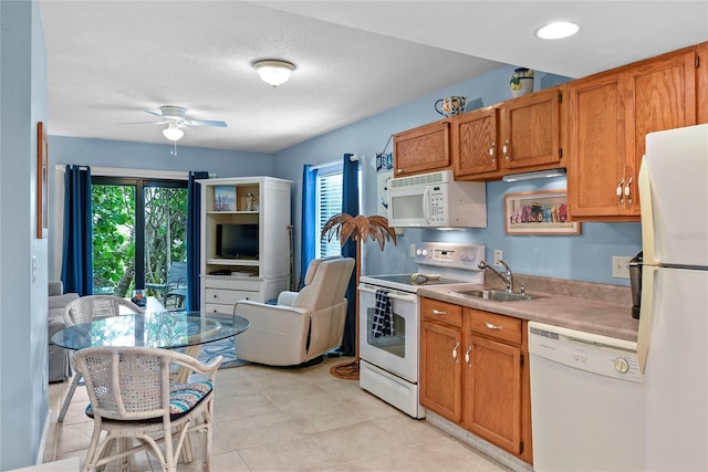 4365 S Atlantic Ave Unit B8, New Smyrna Beach, FL 32169 - kitchen featuring white appliances, a sink, a ceiling fan, light countertops, and light tile patterned floors