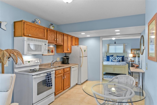 4365 S Atlantic Ave Unit B8, New Smyrna Beach, FL 32169 - kitchen featuring white appliances, a sink, brown cabinets, and recessed lighting
