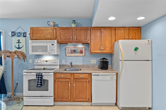 4365 S Atlantic Ave Unit B8, New Smyrna Beach, FL 32169 - kitchen featuring white appliances, a sink, brown cabinets, recessed lighting, and light countertops