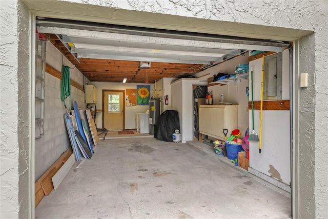 4365 S Atlantic Ave Unit B8, New Smyrna Beach, FL 32169 - garage featuring washing machine and clothes dryer, electric water heater, a garage door opener, and electric panel