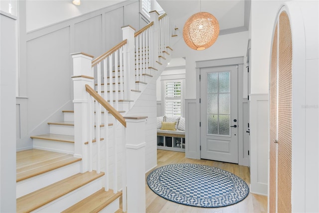 507 S Pine St, New Smyrna Beach, FL 32169 - entrance foyer featuring a decorative wall, wood finished floors, stairs, and a wainscoted wall