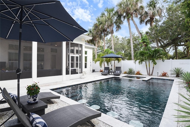 507 S Pine St, New Smyrna Beach, FL 32169 - view of pool featuring a fenced backyard, a patio area, and a sunroom