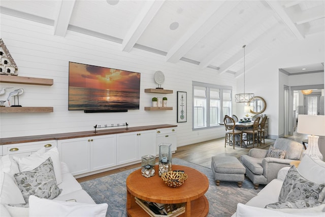 507 S Pine St, New Smyrna Beach, FL 32169 - living room with wood finished floors, wooden walls, and a chandelier