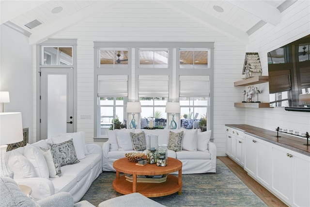 507 S Pine St, New Smyrna Beach, FL 32169 - living area with plenty of natural light, dark wood finished floors, and wooden walls