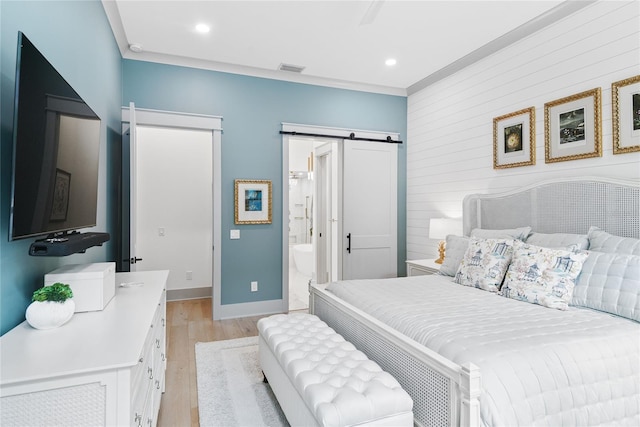 507 S Pine St, New Smyrna Beach, FL 32169 - bedroom featuring a barn door, light wood-type flooring, baseboards, recessed lighting, and wood walls