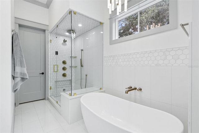 507 S Pine St, New Smyrna Beach, FL 32169 - full bath with a freestanding tub, a stall shower, tile walls, tile patterned flooring, and wainscoting