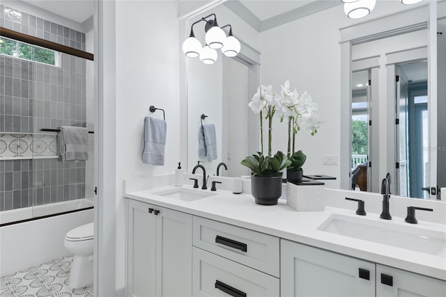 507 S Pine St, New Smyrna Beach, FL 32169 - bathroom featuring double vanity, toilet, and shower / bath combination with glass door
