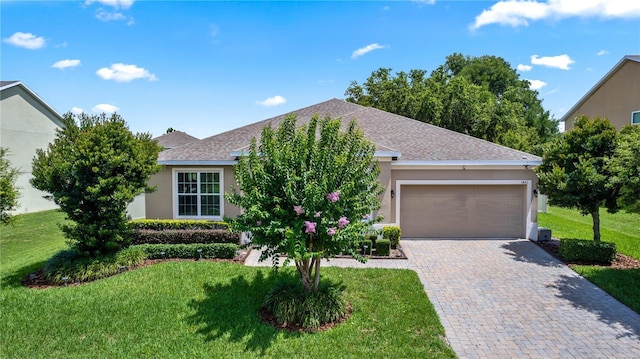 1431 Leitrim Loop, Apopka, FL 32703 - view of front facade with stucco siding, a front yard, a garage, and decorative driveway