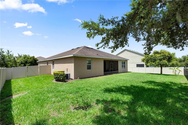 1431 Leitrim Loop, Apopka, FL 32703 - back of property featuring stucco siding, a gate, central AC unit, and a sunroom