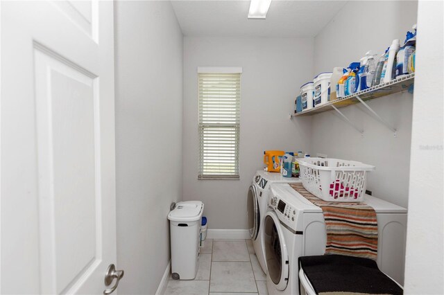 1431 Leitrim Loop, Apopka, FL 32703 - laundry area with independent washer and dryer, light tile patterned flooring, and baseboards