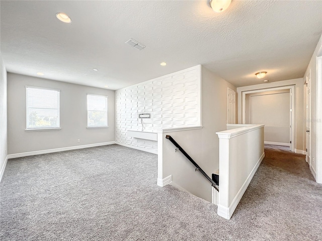 4993 Southlawn Ave, Orlando, FL 32811 - hallway featuring an upstairs landing, carpet, baseboards, a textured ceiling, and recessed lighting