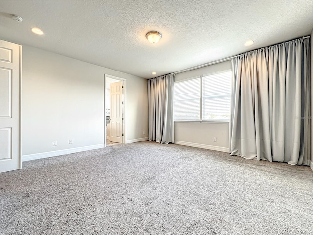 4993 Southlawn Ave, Orlando, FL 32811 - carpeted spare room featuring baseboards, a textured ceiling, and recessed lighting