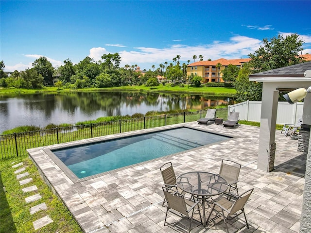 4993 Southlawn Ave, Orlando, FL 32811 - view of swimming pool with a water view, a patio, and a fenced backyard