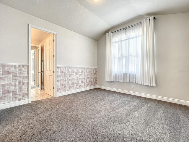 4993 Southlawn Ave, Orlando, FL 32811 - carpeted empty room featuring vaulted ceiling and baseboards