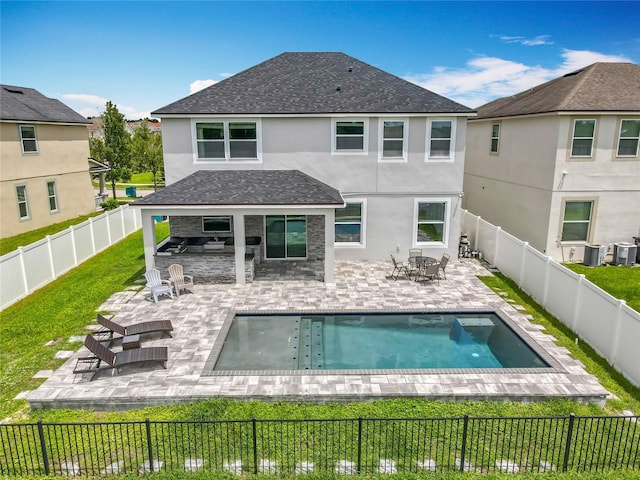 4993 Southlawn Ave, Orlando, FL 32811 - back of house with stucco siding, roof with shingles, and a patio area