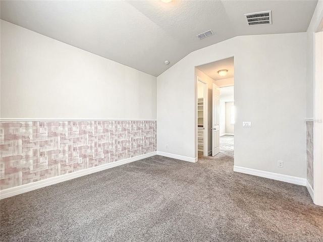 4993 Southlawn Ave, Orlando, FL 32811 - spare room featuring vaulted ceiling, carpet floors, and baseboards