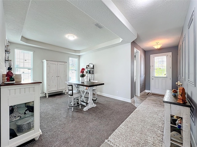 4993 Southlawn Ave, Orlando, FL 32811 - entrance foyer featuring a textured ceiling, a raised ceiling, and baseboards