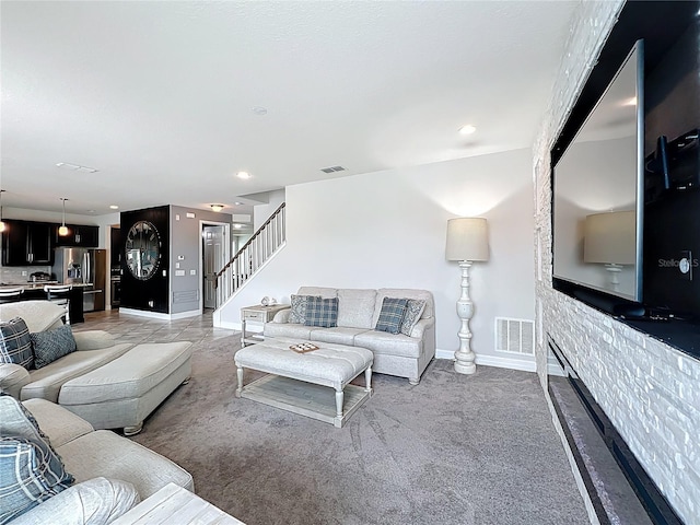 4993 Southlawn Ave, Orlando, FL 32811 - living area with baseboards, stairs, recessed lighting, and light carpet