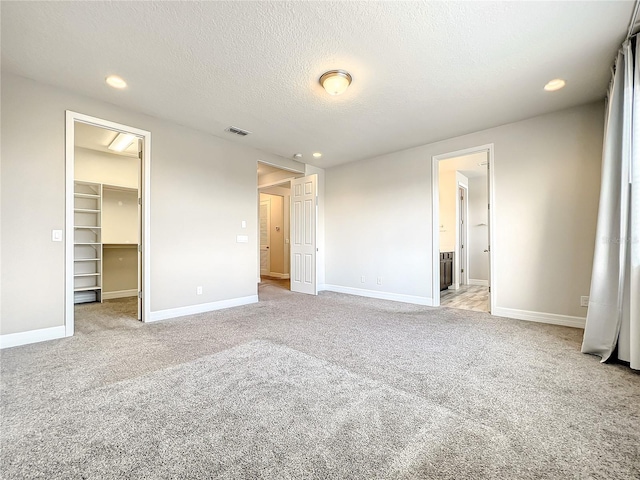 4993 Southlawn Ave, Orlando, FL 32811 - unfurnished bedroom with carpet, a spacious closet, baseboards, recessed lighting, and a closet