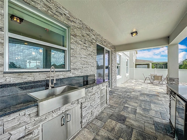 4993 Southlawn Ave, Orlando, FL 32811 - view of patio with a sink, wine cooler, exterior kitchen, and outdoor dining space