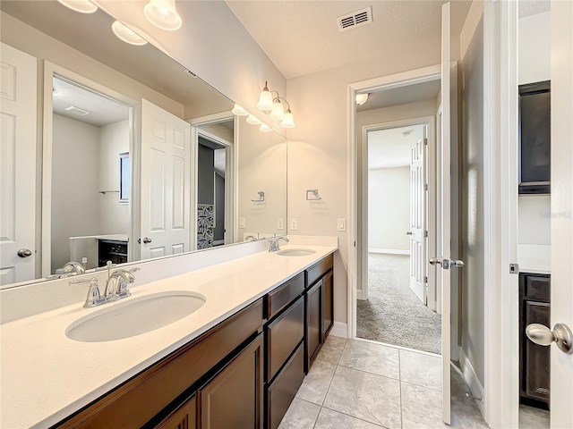 4993 Southlawn Ave, Orlando, FL 32811 - full bath with double vanity, tile patterned floors, and baseboards