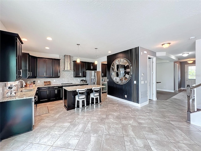 4993 Southlawn Ave, Orlando, FL 32811 - kitchen featuring wall chimney exhaust hood, a sink, stainless steel refrigerator with ice dispenser, backsplash, and a center island