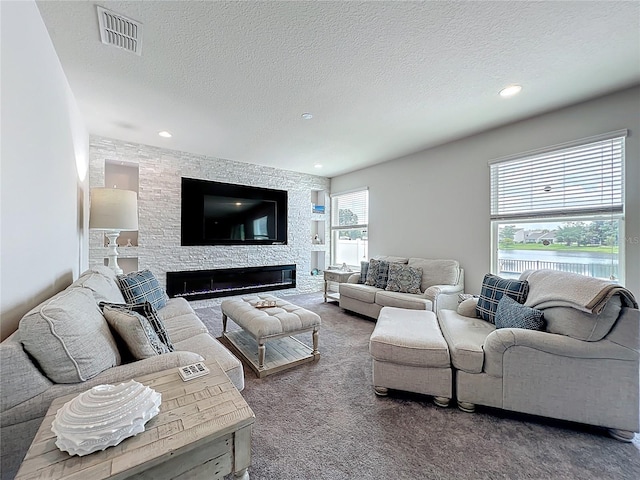 4993 Southlawn Ave, Orlando, FL 32811 - living area with carpet, a textured ceiling, recessed lighting, and a stone fireplace
