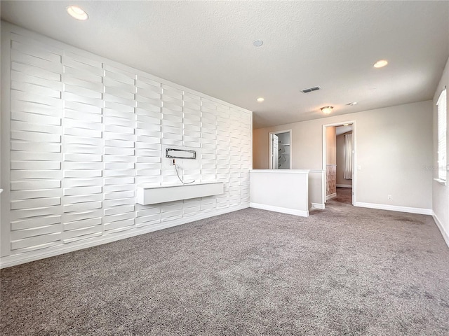4993 Southlawn Ave, Orlando, FL 32811 - unfurnished living room featuring carpet, a textured ceiling, baseboards, and recessed lighting