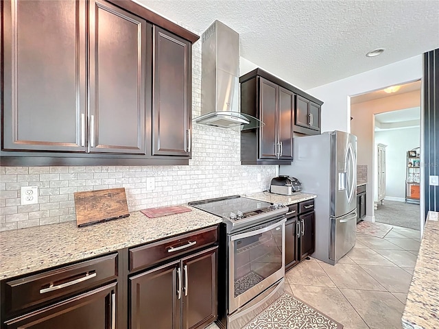4993 Southlawn Ave, Orlando, FL 32811 - kitchen featuring wall chimney exhaust hood, appliances with stainless steel finishes, decorative backsplash, dark brown cabinets, and a textured ceiling