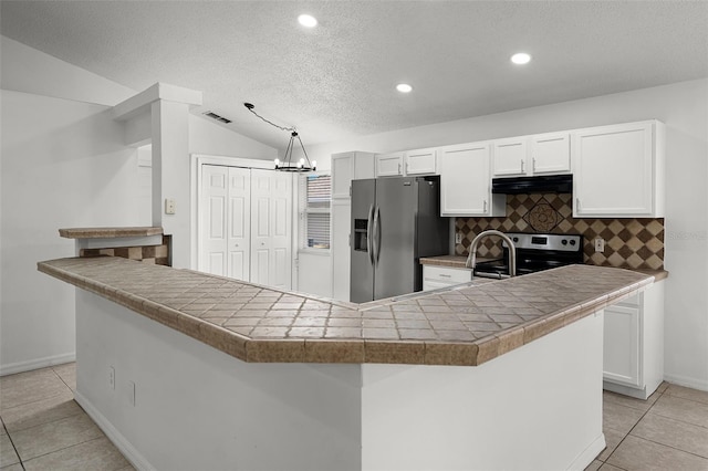 142 Stonegate Pass, Davenport, FL 33897 - kitchen featuring appliances with stainless steel finishes, range hood, light tile patterned floors, decorative backsplash, and white cabinetry