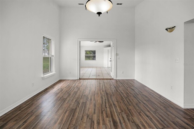 142 Stonegate Pass, Davenport, FL 33897 - spare room with a high ceiling, wood finished floors, and baseboards