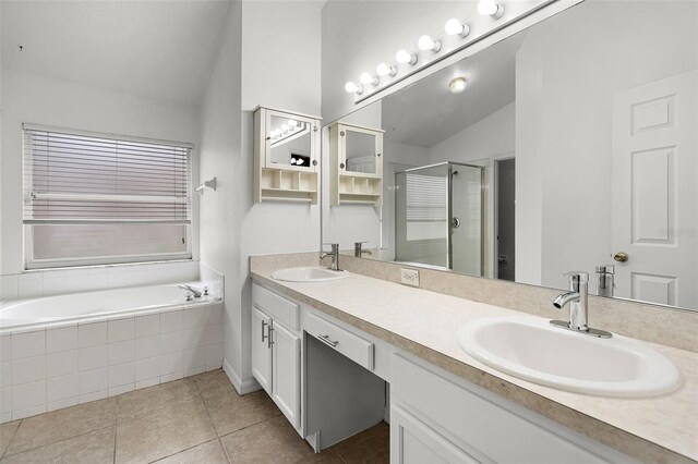 142 Stonegate Pass, Davenport, FL 33897 - bathroom featuring vaulted ceiling, a shower stall, tile patterned flooring, double vanity, and a bath