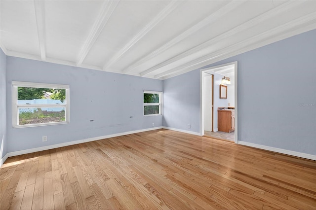 3637 Dubsdread Cir, Orlando, FL 32804 - spare room featuring light wood-style floors, beam ceiling, plenty of natural light, and baseboards