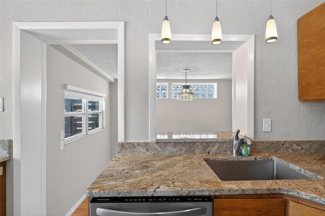 3637 Dubsdread Cir, Orlando, FL 32804 - kitchen featuring a sink, stainless steel dishwasher, stone countertops, pendant lighting, and a textured wall