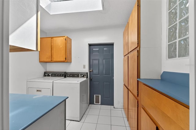 3637 Dubsdread Cir, Orlando, FL 32804 - laundry area with cabinet space, separate washer and dryer, light tile patterned floors, and a skylight