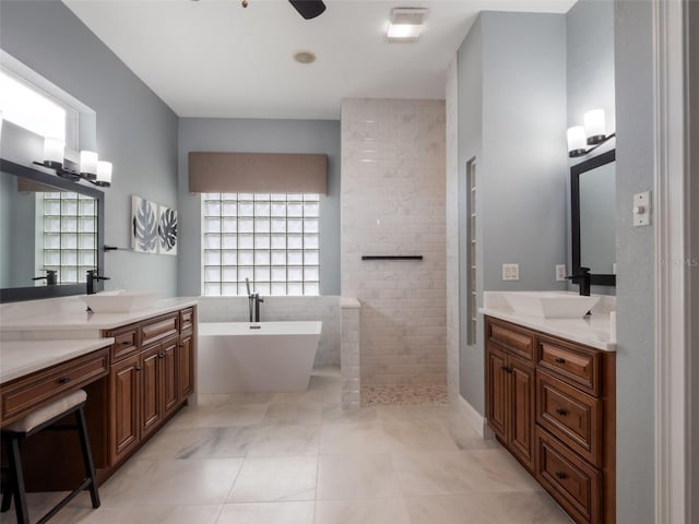 2106 Ridgewind Way, Windermere, FL 34786 - full bath featuring a freestanding tub, two vanities, walk in shower, and tile patterned flooring