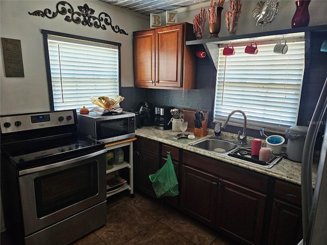 3910 Orange Ave, Coleman, FL 33521 - kitchen featuring appliances with stainless steel finishes, dark tile patterned floors, and light countertops
