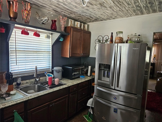 3910 Orange Ave, Coleman, FL 33521 - kitchen with stainless steel fridge with ice dispenser, light countertops, wood ceiling, and dark brown cabinets
