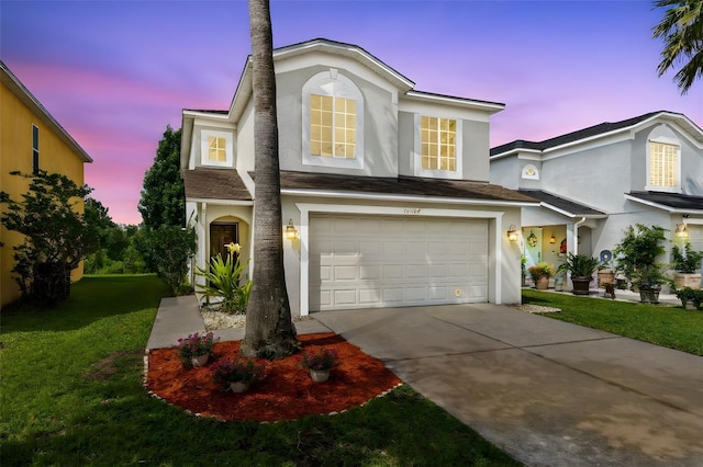 15324 Black Lion Way, Winter Garden, FL 34787 - traditional-style home with stucco siding, driveway, an attached garage, and a yard