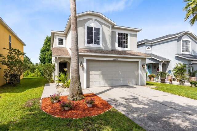 15324 Black Lion Way, Winter Garden, FL 34787 - traditional-style home with stucco siding, a front yard, concrete driveway, and an attached garage