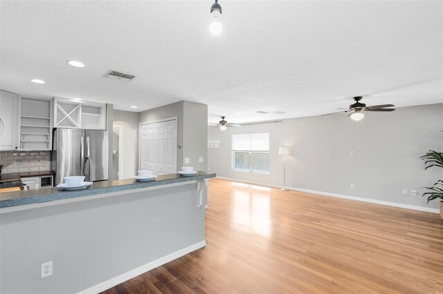 15324 Black Lion Way, Winter Garden, FL 34787 - kitchen featuring open shelves, freestanding refrigerator, a ceiling fan, baseboards, and light wood-type flooring