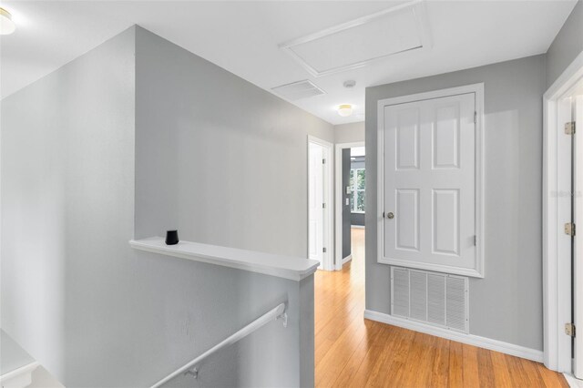 15324 Black Lion Way, Winter Garden, FL 34787 - hall featuring an upstairs landing, light wood-style flooring, attic access, and baseboards