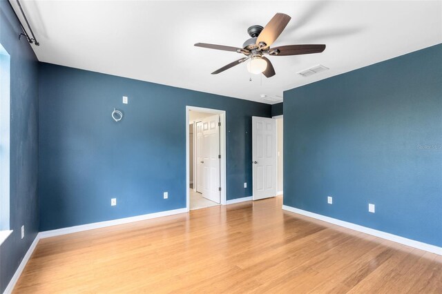 15324 Black Lion Way, Winter Garden, FL 34787 - unfurnished bedroom featuring baseboards, light wood-style floors, and ensuite bath