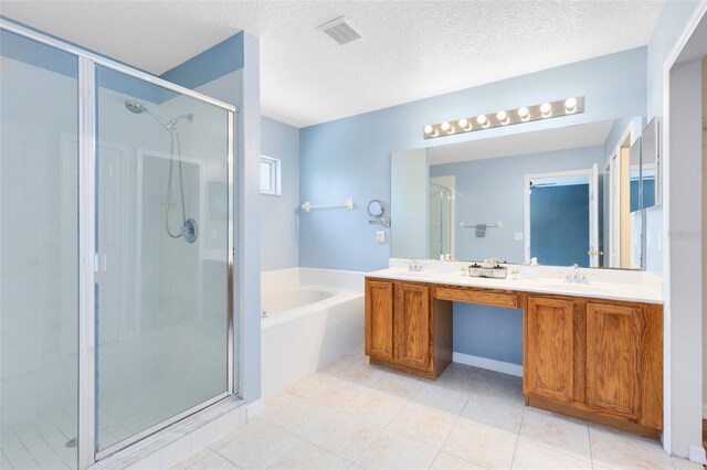 15324 Black Lion Way, Winter Garden, FL 34787 - full bath featuring a shower stall, a garden tub, double vanity, a textured ceiling, and tile patterned floors