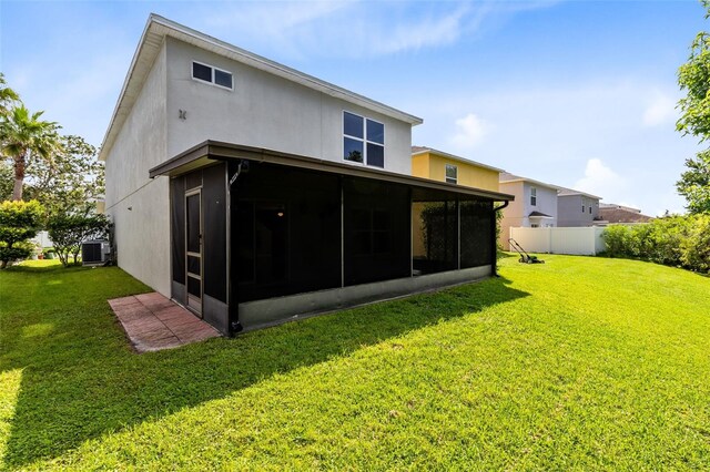 15324 Black Lion Way, Winter Garden, FL 34787 - rear view of property featuring a sunroom, central air condition unit, and stucco siding