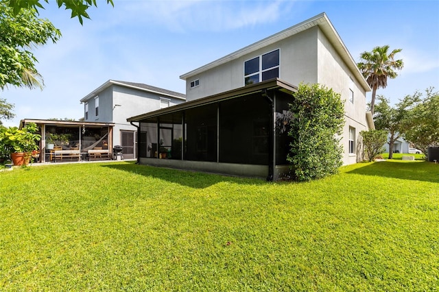 15324 Black Lion Way, Winter Garden, FL 34787 - back of house featuring a sunroom, a yard, and stucco siding