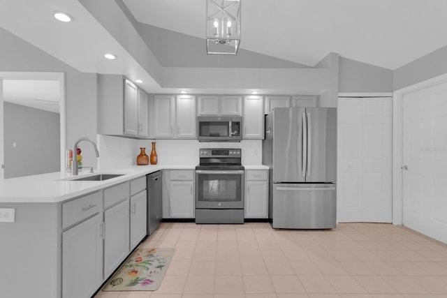 625 Nighthawk Cir, Winter Springs, FL 32708 - kitchen featuring appliances with stainless steel finishes, a sink, light countertops, a peninsula, and vaulted ceiling
