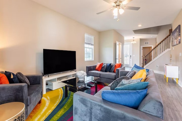 7951 Haverhill Way, Kissimmee, FL 34747 - living area featuring wood finished floors, a ceiling fan, stairway, recessed lighting, and baseboards